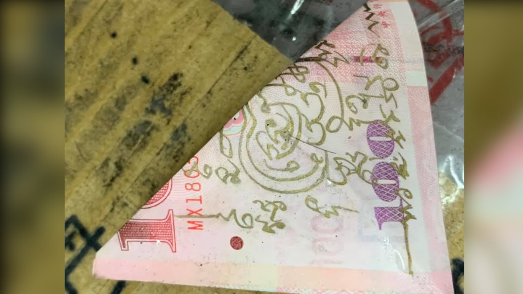 民眾見到面額100元台幣，但上頭卻畫有奇異符號及文字。（圖／Facebook爆料公社公開版）