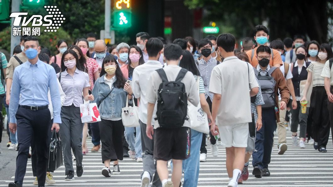 圖為台北市信義區下班人潮，民眾在戶外仍戴好口罩。（圖／中央社）