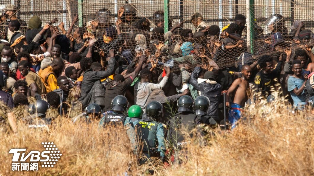 摩洛哥邊境非法移民試圖闖過圍籬。（圖／達志影像美聯社）