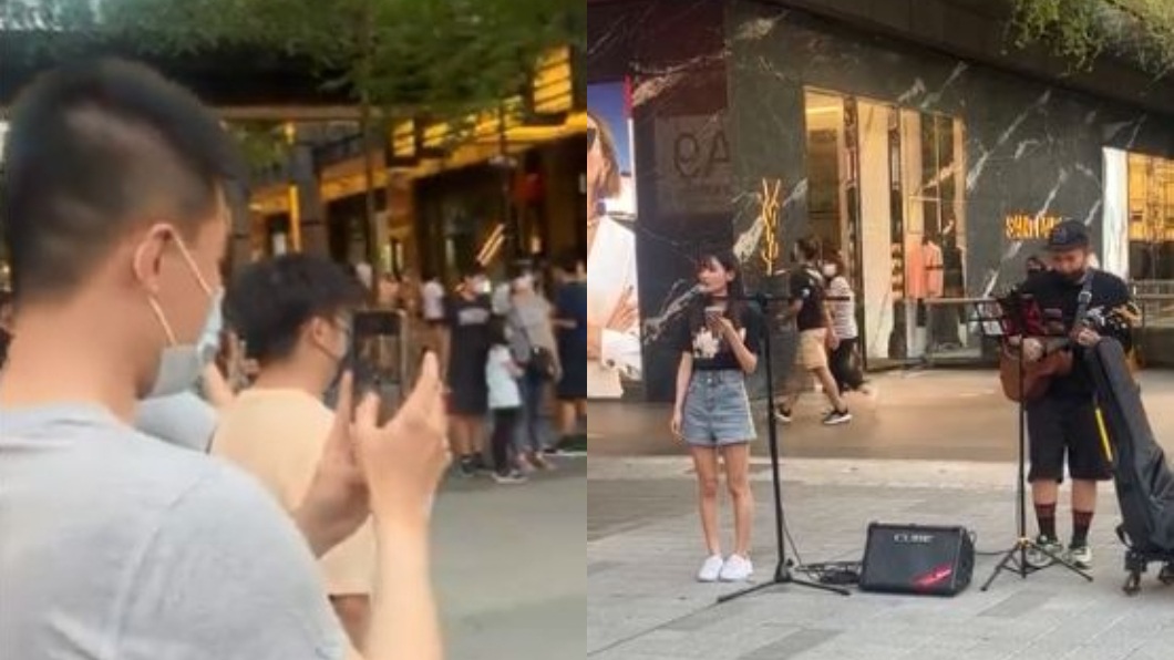 信義區街頭日前有一名正妹獻唱讓路人停下圍觀拍攝。（圖／翻攝自爆廢公社二館）