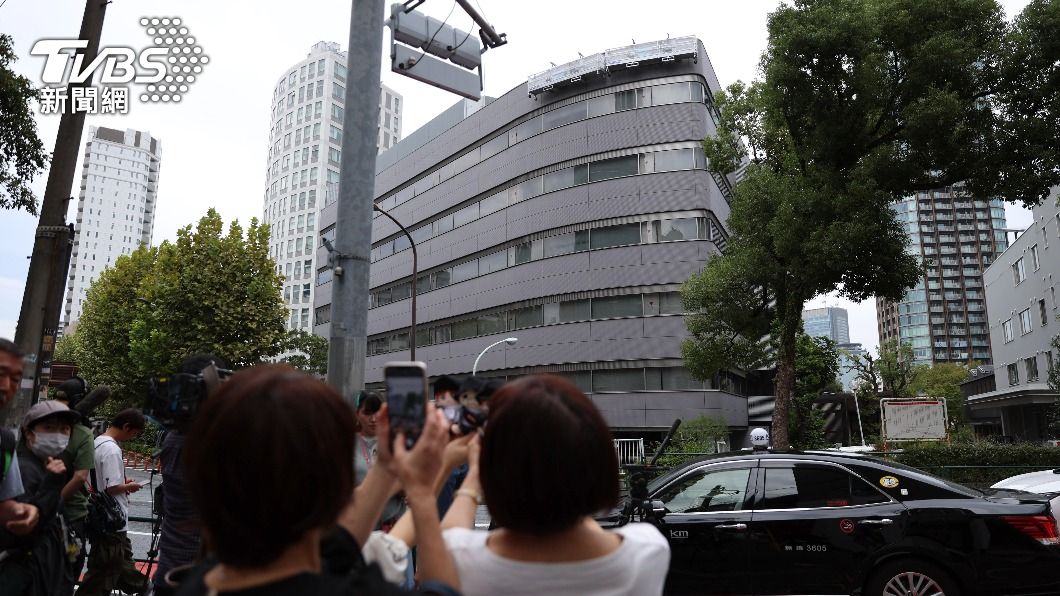 傑尼斯在東京都港區的總部大樓招牌被拆除，有粉絲帶著藝人的娃娃等周邊商品到現場拍照留念。（圖／達志影像美聯社）