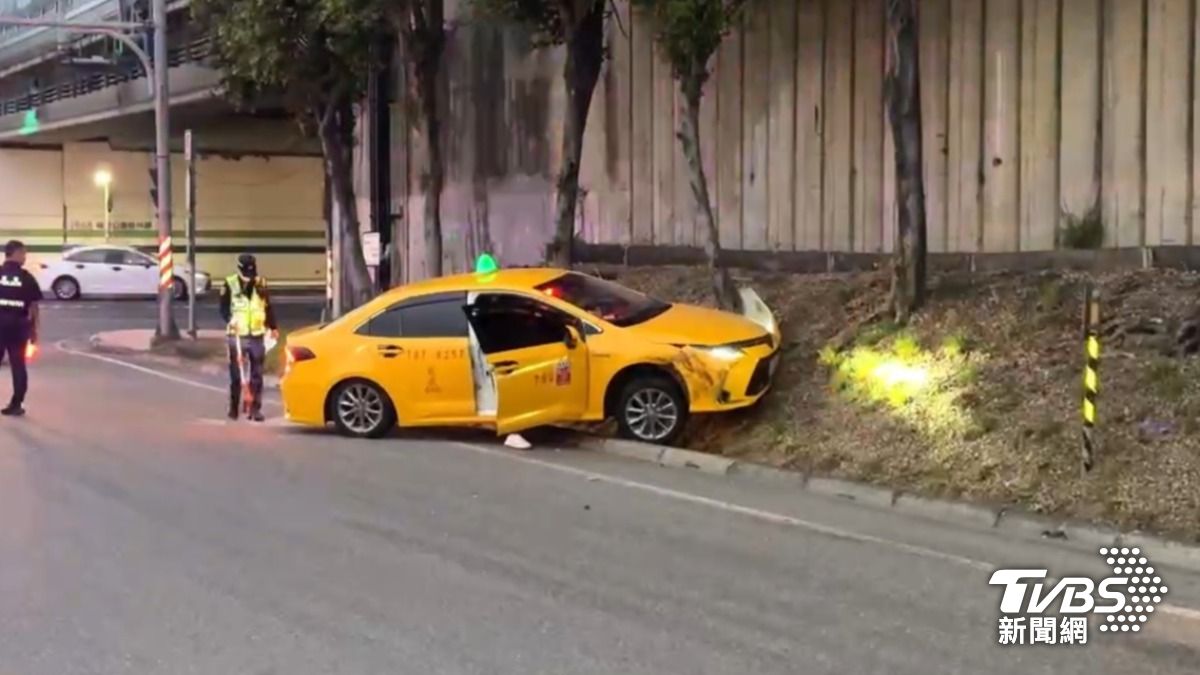 計程車衝向高速公路邊坡卡住。（圖／TVBS）
