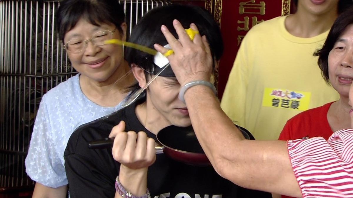 郭忠祐在遊戲中連續遭砸2顆生雞蛋,其中還被胡瓜砸,整張臉都沾滿了蛋液。(圖/民視提供)